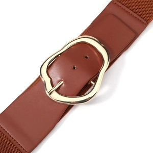 Macro view of brown leather elastic belt with golden irregular metal buckle closure