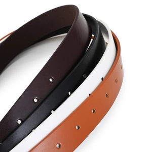 Detail of four colorful thin leather belts with circular holes and classic buckles