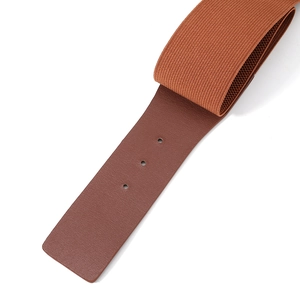 Close-up of brown elastic waist belt showing leather texture and adjustment holes