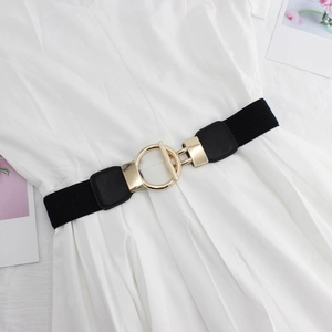 Detail of minimalist gold interlocking ring buckle on black elastic waist belt for women
