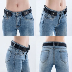 Detail view of black no-buckle elastic belt with leather ends on blue denim jeans