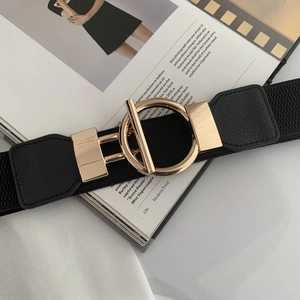Detail of black elastic wide waist belt with gold round ring and T-bar metal buckle closure