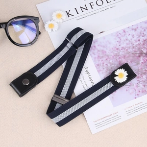 Detail of navy blue elastic buckle-free belt with daisy accent and snap button closure
