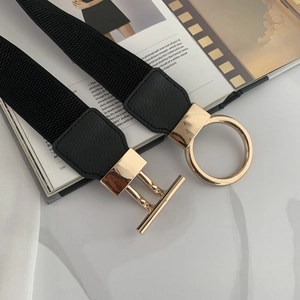 Detail of black elastic waist belt featuring a gold alloy OT buckle on leather panels