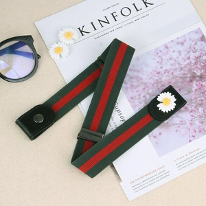 Detail of red and green elastic no-buckle belt with daisy floral accent and leather ends