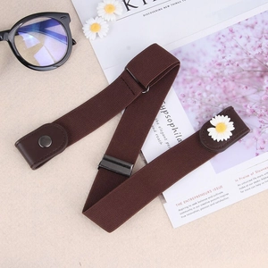 Detail of dark brown elastic no-buckle belt with daisy accent and adjustable metal slide
