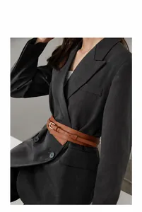 Brown leather wide waist belt with double straps and golden buckle on gray blazer