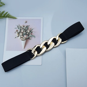 Women's black elastic waist belt featuring a bold gold metal chain link buckle detail