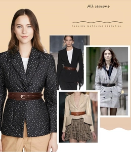 Detail of thin fashion belt with golden metal E-buckle on suit, coat and dress