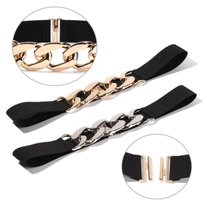 Detail view of elastic waist belt set with thick gold and silver metal chain links