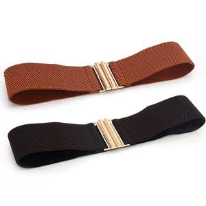 Detail showing elastic wide waist belts in black and brown with golden metal buckle