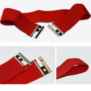 Detail of red elastic wide waist belt with golden buckle for dresses and coats