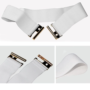 Detail view of white elastic wide belt with textured fabric and gold metal buckle