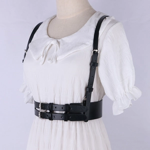 Detail of black punk waist belt harness with silver buckles on white dress