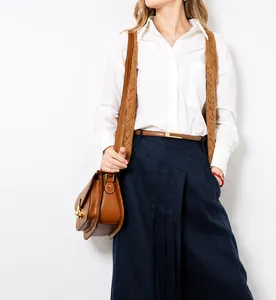 Classic brown leather thin belt with gold buckle styled on white shirt and vest outfit