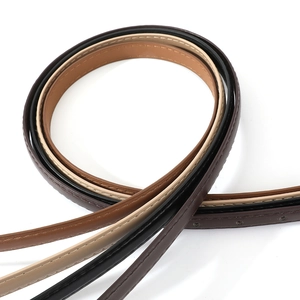 Detail of four colorful slim PU leather belts with fine stitching and adjustable holes