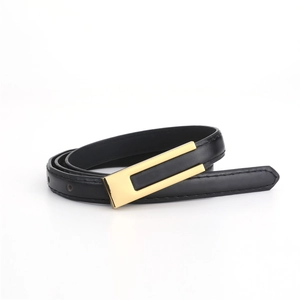 Détail d'une ceinture fine noire avec boucle rectangulaire dorée pour un style chic