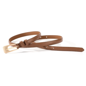 Detail of slim dark brown PU leather belt for women with elegant gold metal buckle