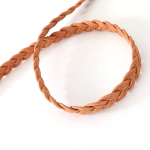 Macro shot of brown braided wax rope belt featuring intricate woven texture and knot