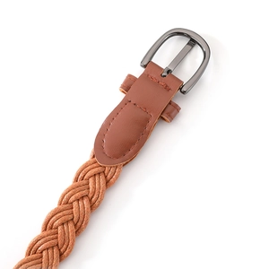 Detail of vintage braided wax rope belt showing brown twist texture and silver buckle