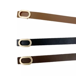 Set of three narrow leather belts for women with oval gold buckles in black, tan, and brown