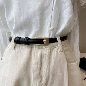 Classic black slim PU leather belt for women featuring a matte gold pin buckle on jeans