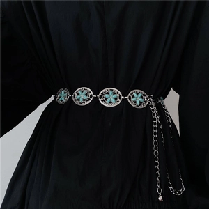 Nahaufnahme einer Vintage-Bohème-Taillenkette mit Türkisinlay auf schwarzem Kleid