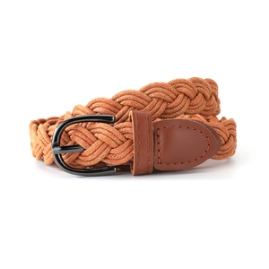 Detail of woven braided wax rope belt with a polished black metal buckle and leather end cap