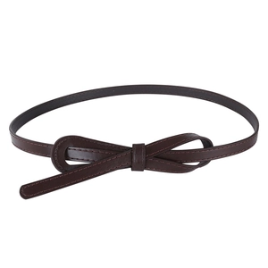 Close-up of a slim dark brown faux leather belt featuring a decorative bow knot detail