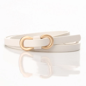 Detail of white PU leather skinny belt with matte gold infinity buckle on mirror surface