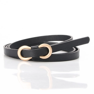 Close-up of black PU leather skinny belt with golden double ring buckle and litchi texture