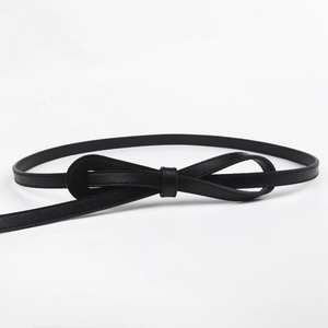 Classic black leather skinny belt for women featuring an elegant bow tie knot design