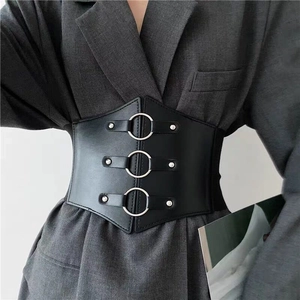 Detail of wide black PU leather waist belt with three silver metal rings and rivets