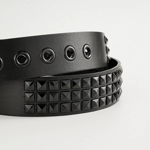 Punk black leather belt with three rows of pyramid studs and metal eyelet details