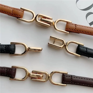 Three minimalist slim leather belts for women with gold interlocked geometric buckles