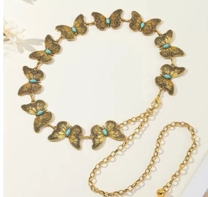 Detail of vintage butterfly waist chain with turquoise inlay and gold ball pendant charm