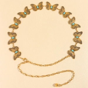 Detail of golden butterfly chain belt with turquoise insets and lobster clasp