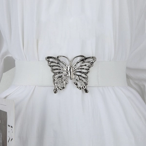 Détail de la boucle papillon argentée avec strass sur ceinture élastique blanche