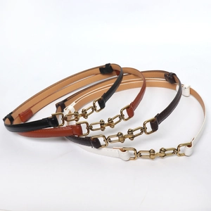 Set of four thin leather waist belts in black, tan, coffee and white with gold chain buckles