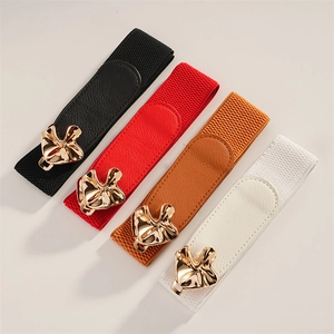 Detail of four colorful elastic waist belts with golden wavy metal buckle fasteners
