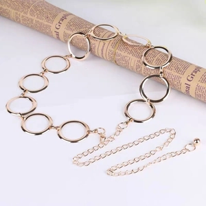 Detail view of interlocking gold metal rings and adjustable chain with a small ball charm