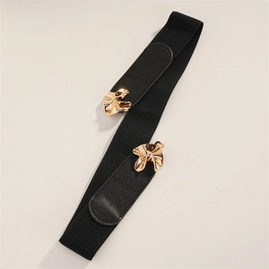 Detail of a chic black elastic waist belt featuring a gold floral-shaped metal buckle