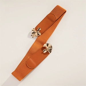 Detail of a brown elastic waist belt featuring a unique gold wavy metal buckle closure