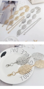 Close-up of golden and silver metal leaf belt with hollowed texture and lobster clasp