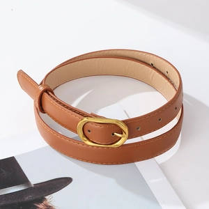 Close-up of brown PU leather belt with vintage golden oval buckle and fine stitching
