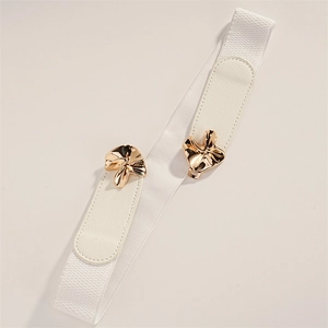 Close-up of gold irregular curved metal buckle and white elastic waistband detail