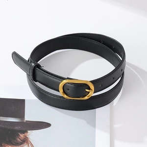 Detail view of black PU leather belt with vintage gold buckle and neat stitching on edges