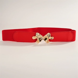 Detail of red elastic waist belt featuring a gold bow buckle and faux leather accents