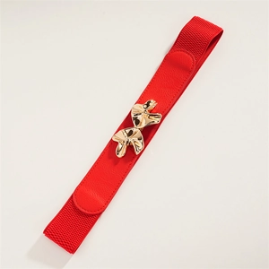 Detail of red elastic waist belt featuring a gold mushroom-shaped buckle and lychee texture