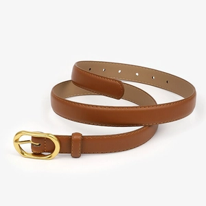 Detail of camel brown leather belt with gold oval buckle and fine stitching on white background